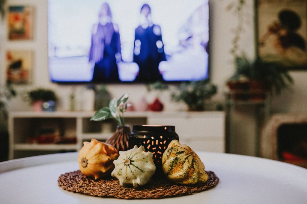 Warm and inviting indoor scene featuring decorative gourds and ambient lighting on a table.