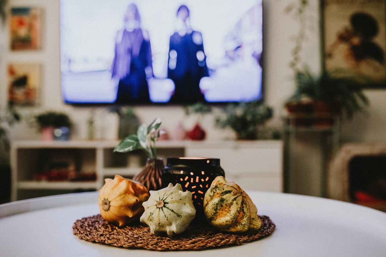 Warm and inviting indoor scene featuring decorative gourds and ambient lighting on a table.